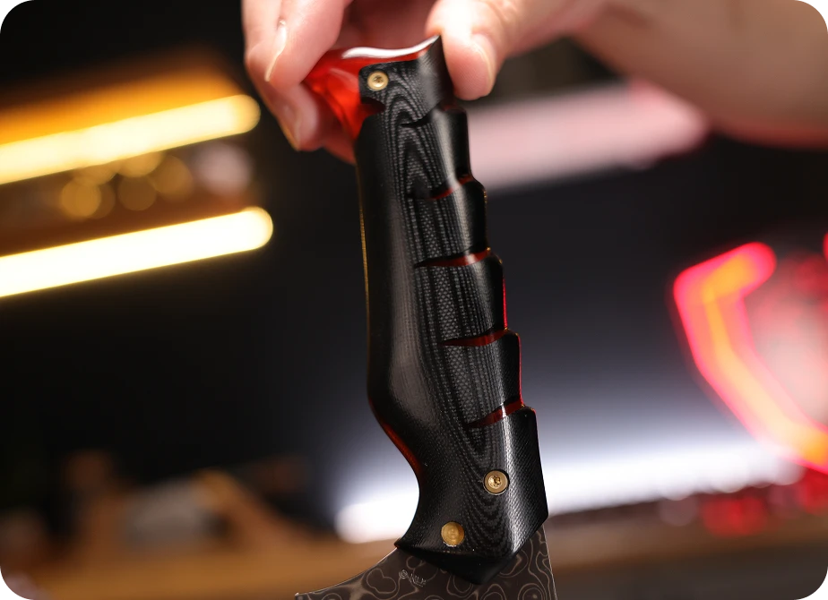 <h4>Black G10, veined with fire.</h4><p>Dense, durable, near-impervious to moisture and heat — the dark rock the fire runs through, with translucent amber-orange resin threaded between the layers.</p>